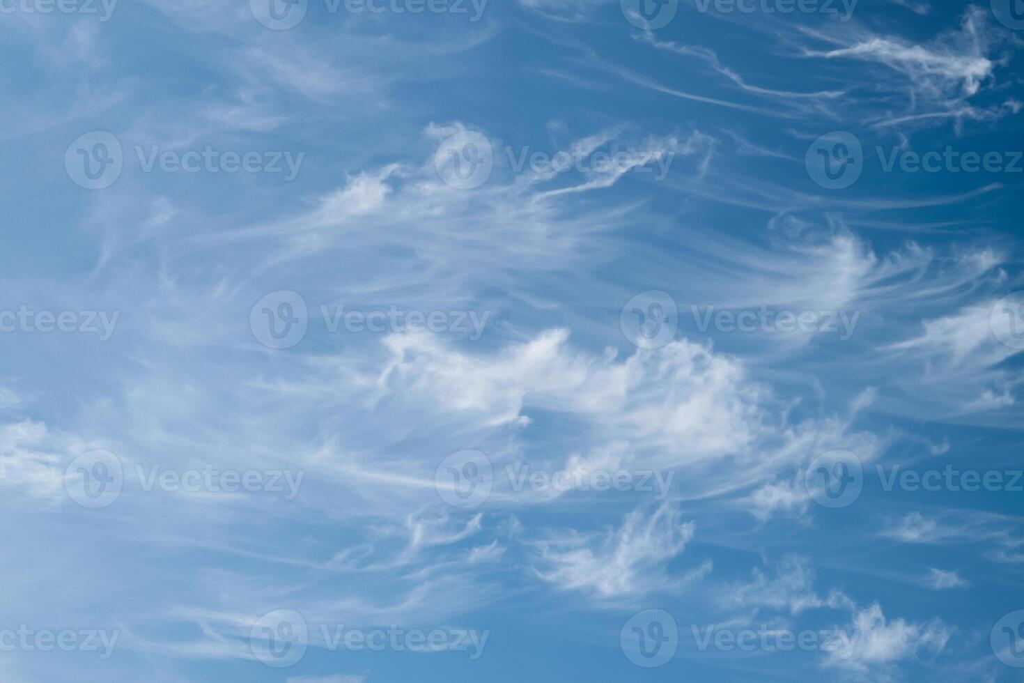 Joyful Sunny Day, Beautiful Wispy Cirrus Clouds in the Blue Sky, Symbolizing Freedom and Energize photo