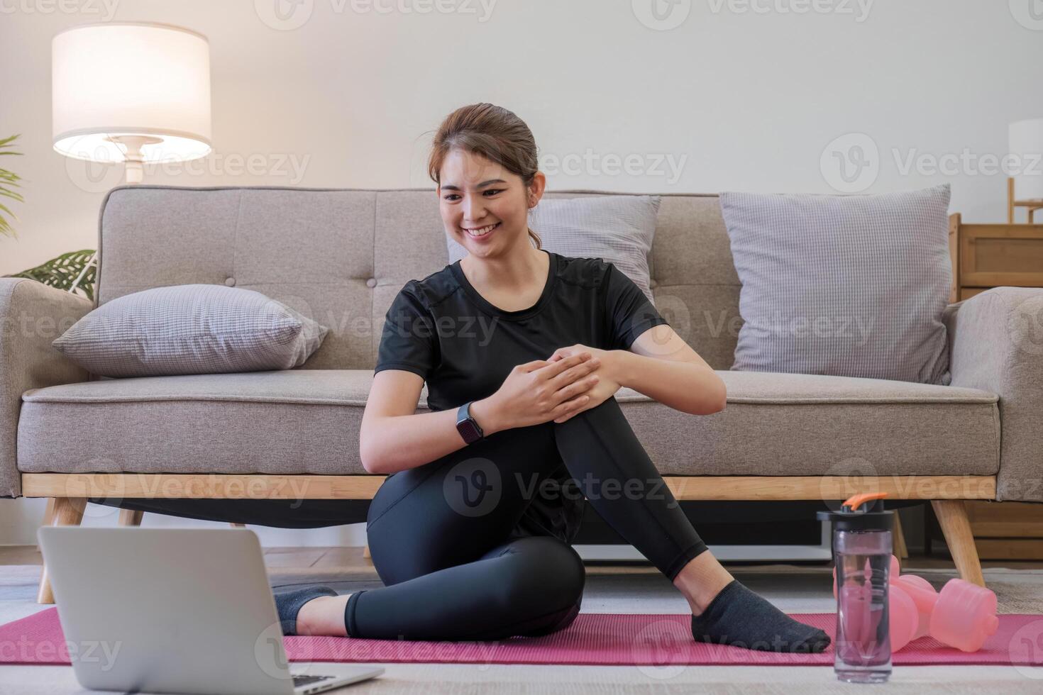 Young Asian sporty fitness woman coach do practice video online training yoga laptop in living room at home photo