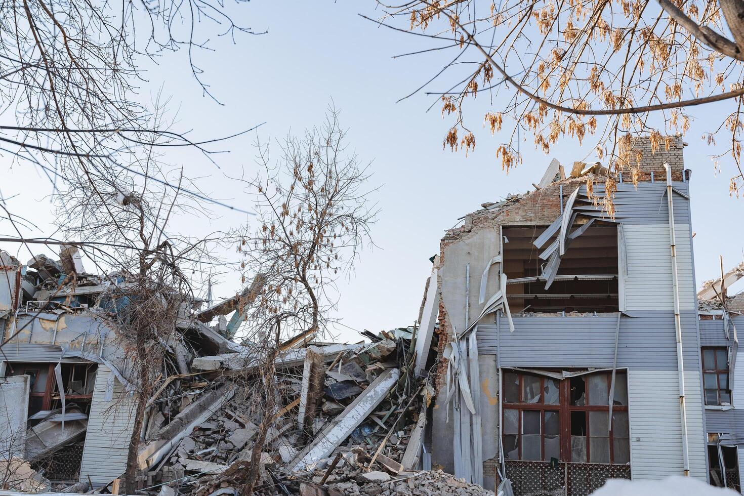 The center of the house is destroyed by the explosion, the collapse of the construction site. The building was damaged after the earthquake. Disaster at work. The factory fell a pile of stones. photo