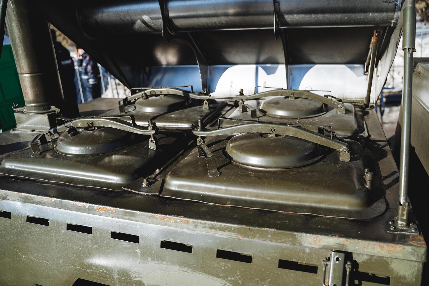 Close-up of the army kitchen. Boilers for cooking for soldiers. Military thermos for porridge. The green color of the mobile kitchen. photo