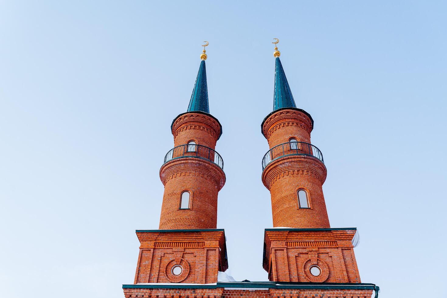 The mosque is made of red brick. Minaret. A majestic religious building. The House of God. A place for prayers of believers. photo