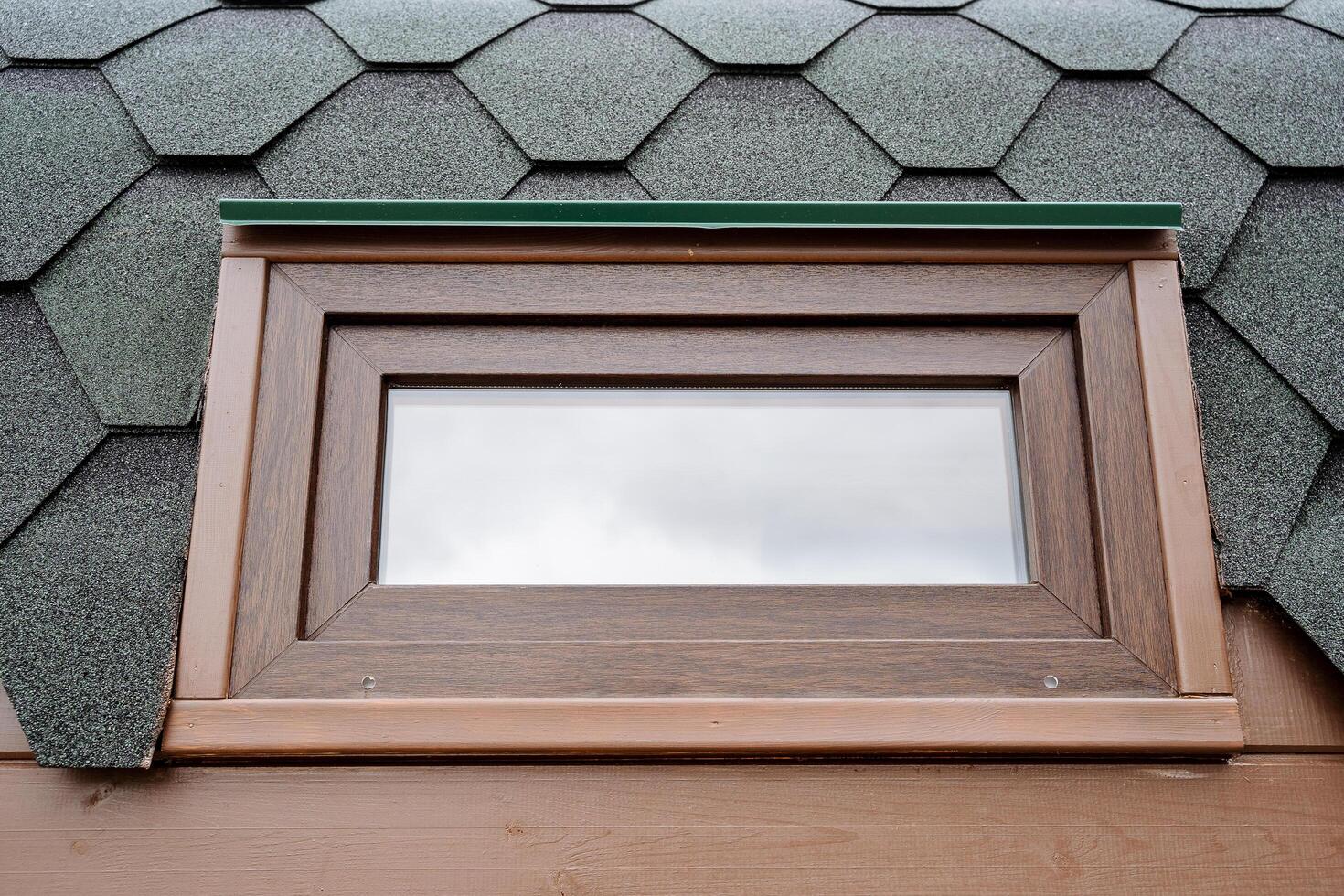 Double-glazed windows for a country house, a small window of euro class, a brown frame, glass for an aluminum frame, a facade of a building from the street, a mobile sauna window photo