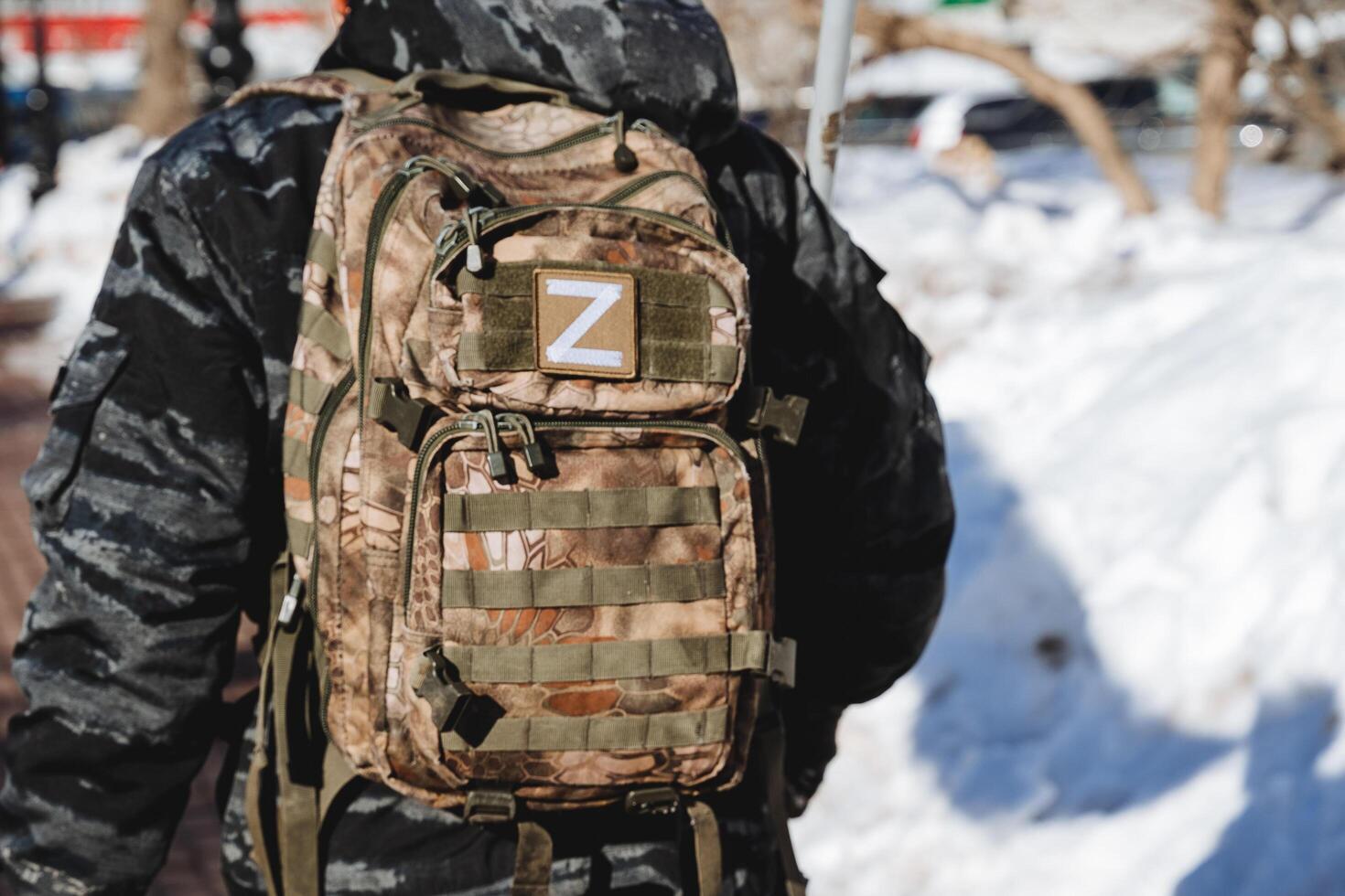 Military equipment of a soldier of the Russian army viewed from behind. The backpack is specially camouflage colored. photo