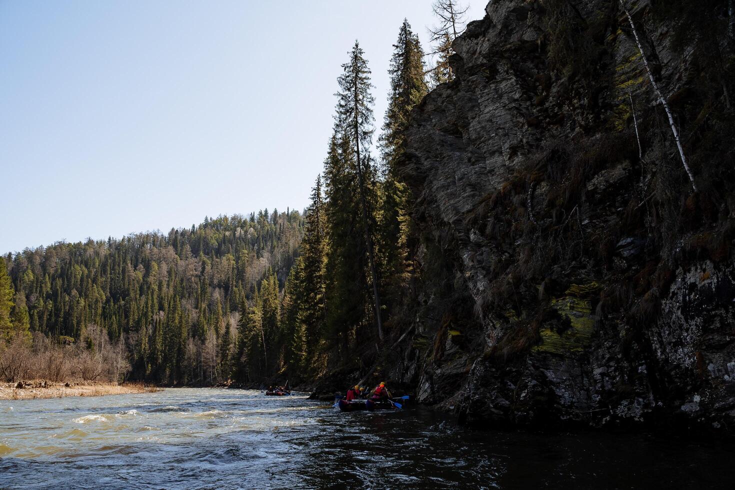 Southern Urals tourists raft along the river rafting on the water, the landscape of a mountain river, a dark coniferous forest. photo