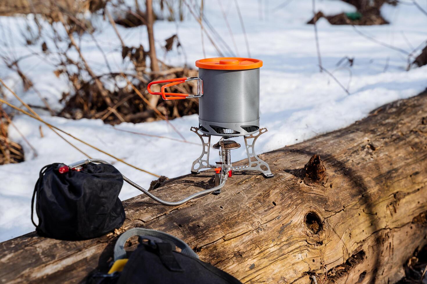 Camping utensils, camping equipment, cook food on the fire in the forest, gas burner compact light, metal pot,. photo