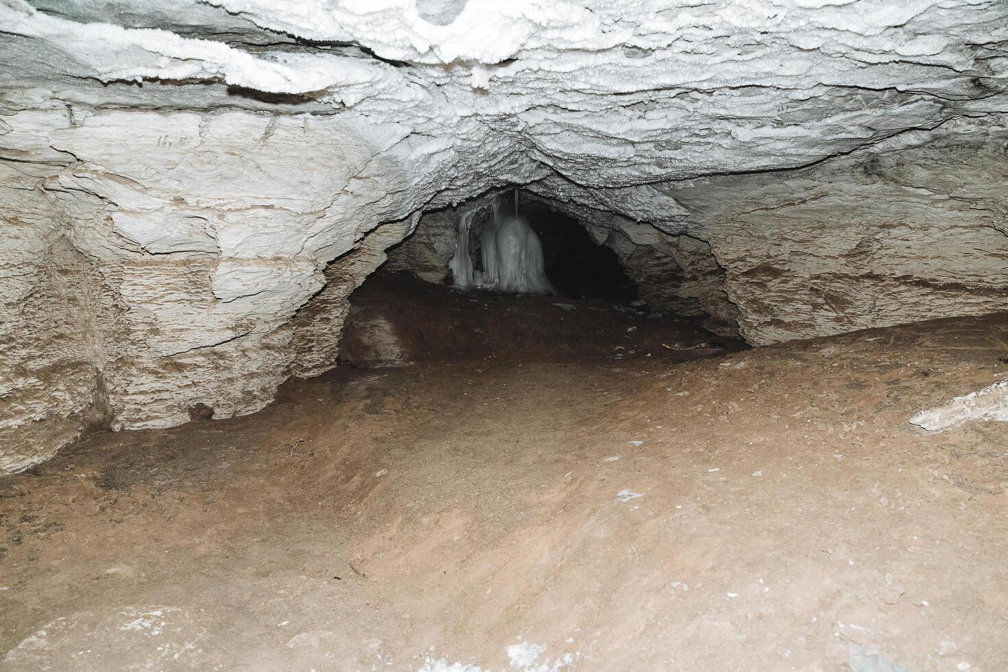 Underground cave deep, long passage in the karst cavity of the mountain, darkness at the end of the tunnel, speleology, photo