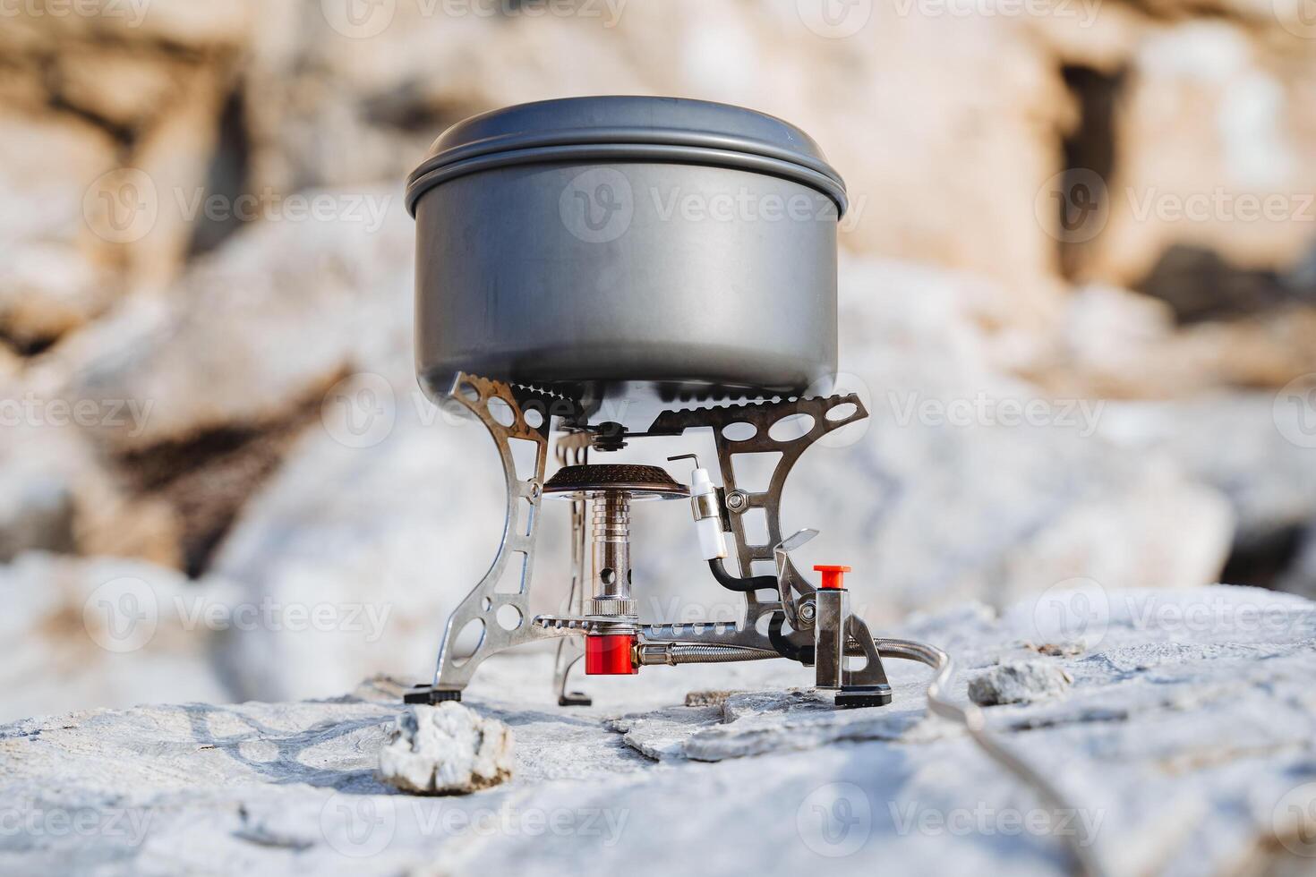 Tourist gas burner for cooking, dishes stand on fire, aluminum pan, camp kitchen, mountaineering equipment, convenient to cook photo