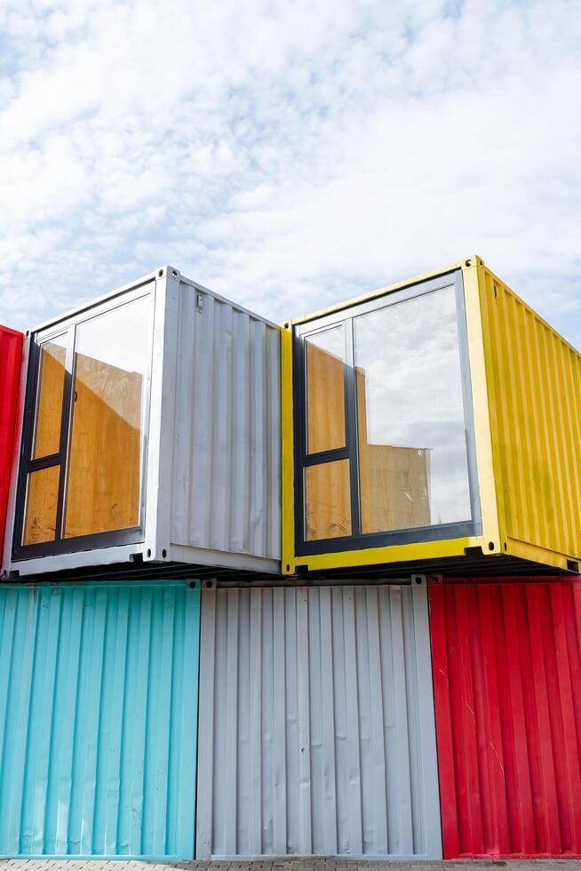 Colorful bright shipping containers stand in the city, iron profile, shipment of metal boxes, transparent window for entry. photo