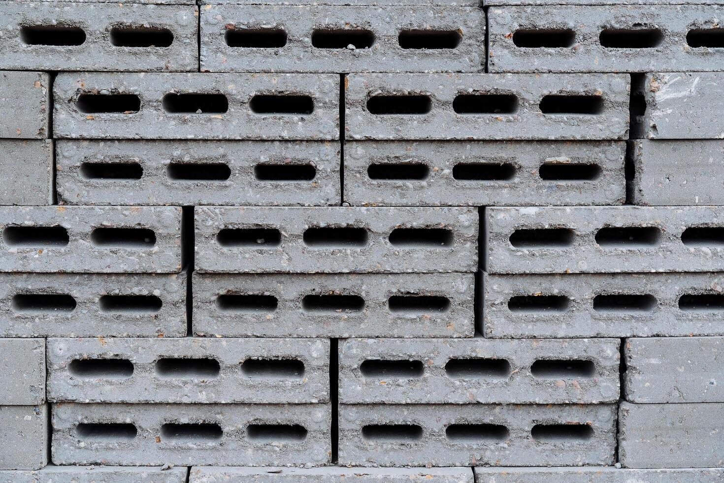 Concrete blocks are macro photography, gray bricks are made of cement, holes in the stone, building material, a stack of bricks. photo