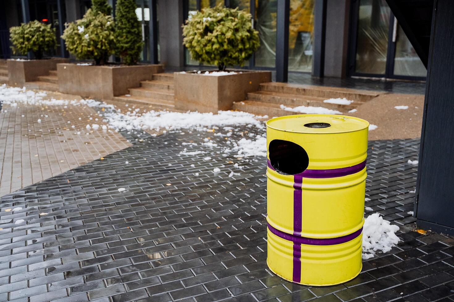 Brightly painted garbage container. An urn made of a metal barrel. Cleanliness on the streets of the city, improvement of the district. photo