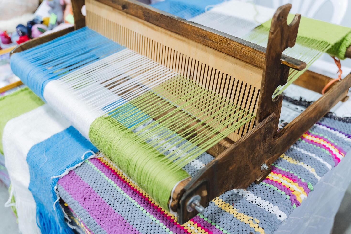 A loom for sewing. Woolen threads of different colors are tucked into the embroidery machine. Handmade objects of folk art. photo