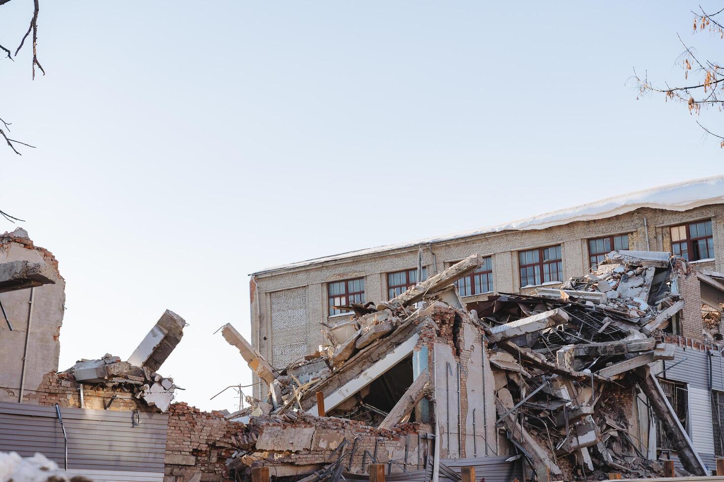 The demolition of the walls of the building, the destruction of the old house, the wreckage of the dwelling, the factory destroyed to the ground, a pile of garbage. photo