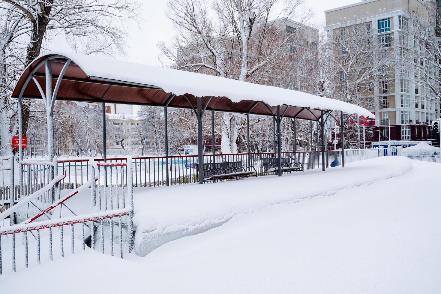 The railway station is covered with snow. Snowdrifts on the platform. Consequences of snowfall. Blizzard in the city.. photo