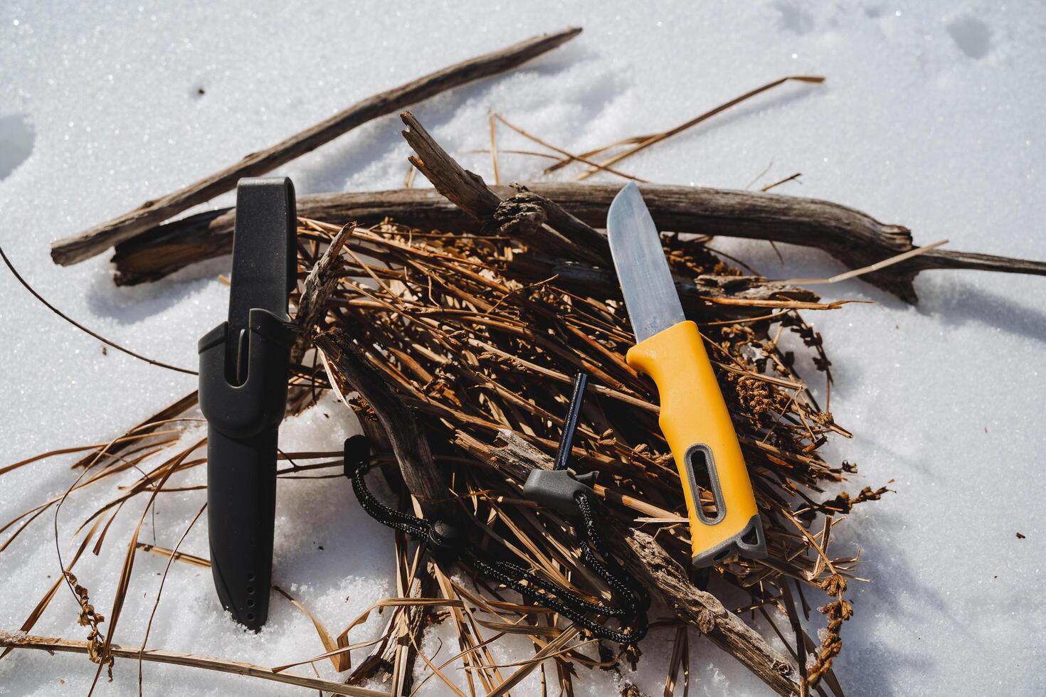 The knife lies on the wood, the tourist's equipment for making a fire. Survival in the wild in winter. photo