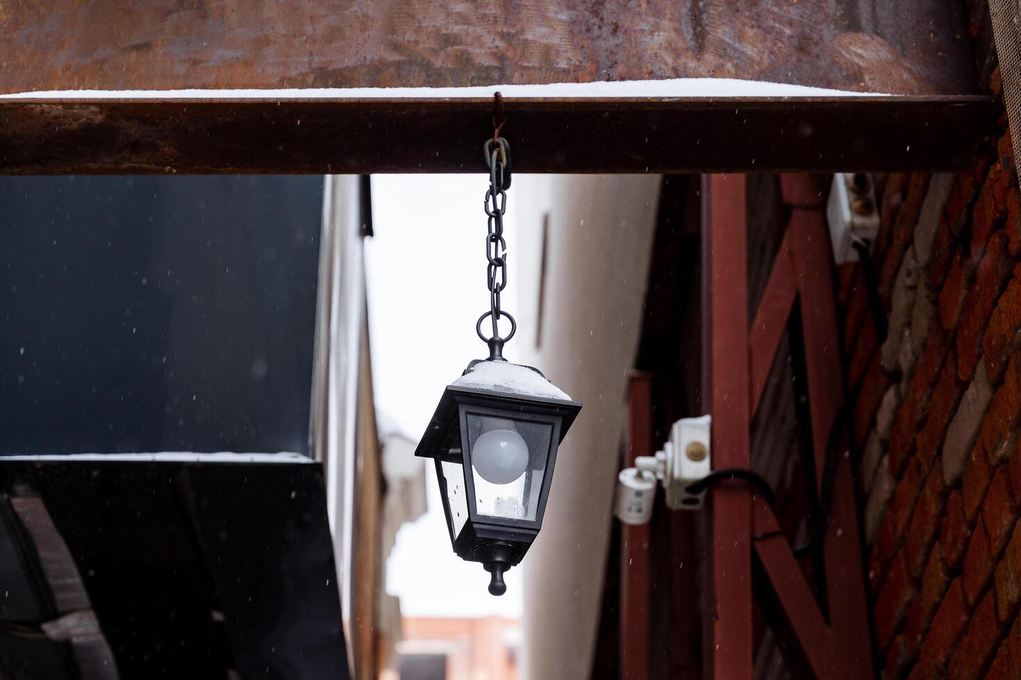 Street lamp on the beam. Vintage street lamp. Cityscape. Night lighting in dark alleys photo