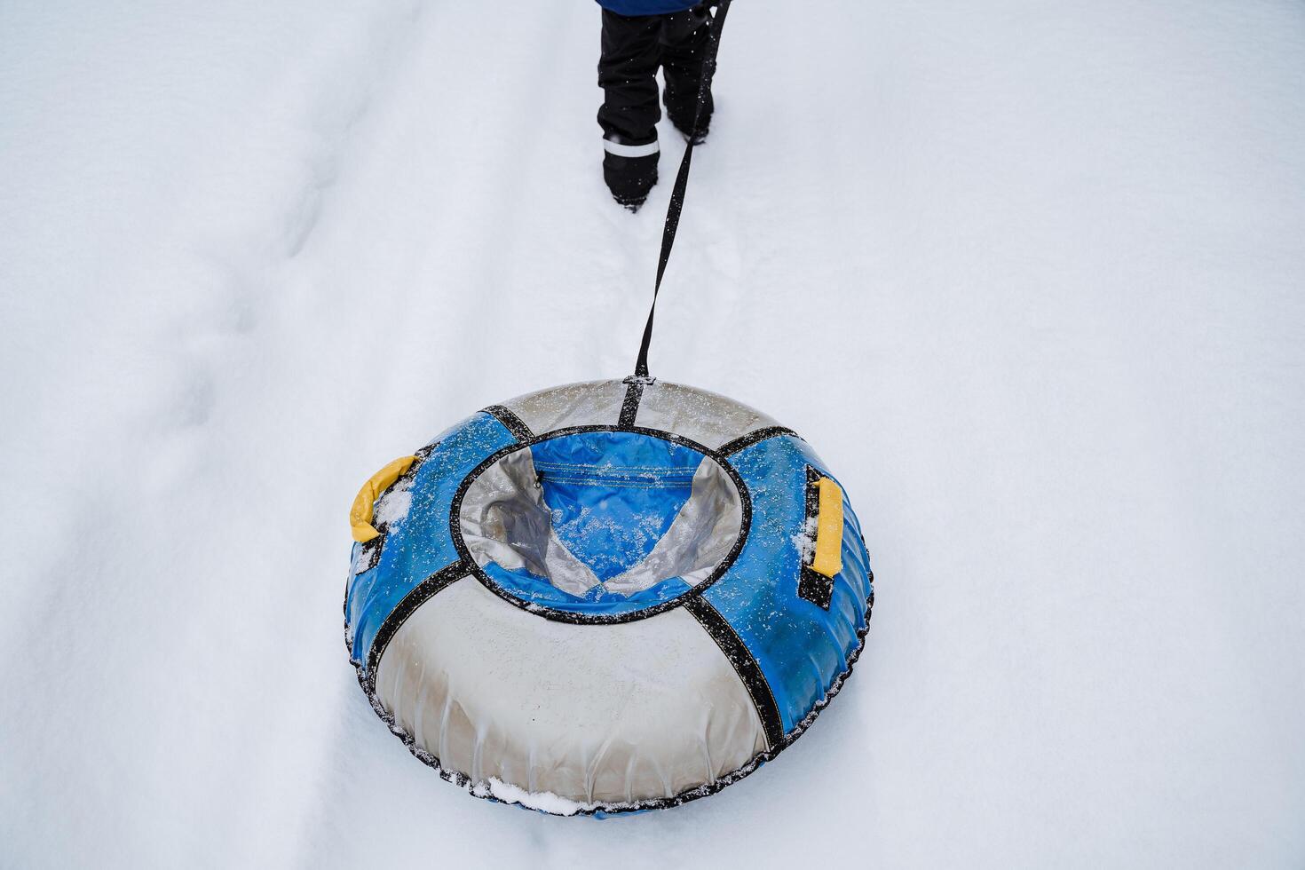 Tubing vatrushka. Winter entertainment on the slide. Inflatable sledding in the snow or on the water. photo