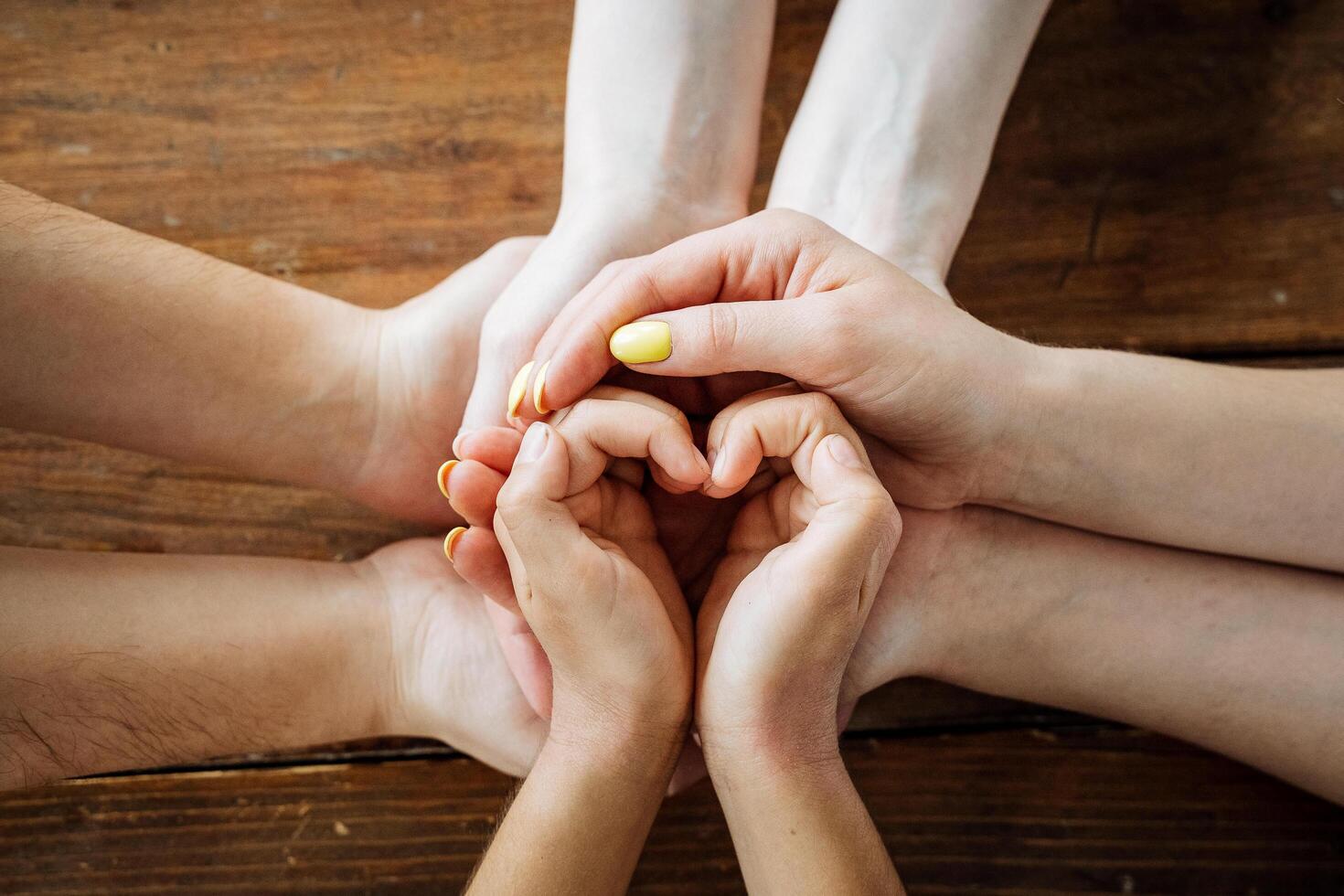 The heart is assembled from the hands of people, the shape of the heart from the fingers, the children's hands. photo