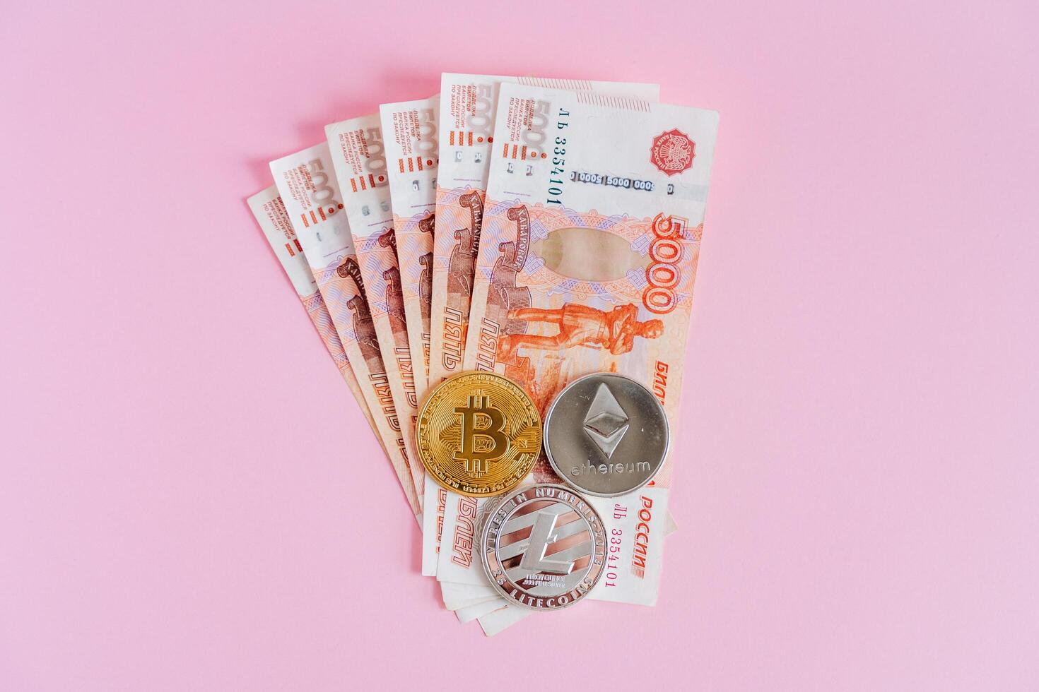 Russia exchanges money for cryptocurrency. Exchange of rubles for bitcoin, ethereum. A new way to invest money. Litecoin coins are on paper money. photo