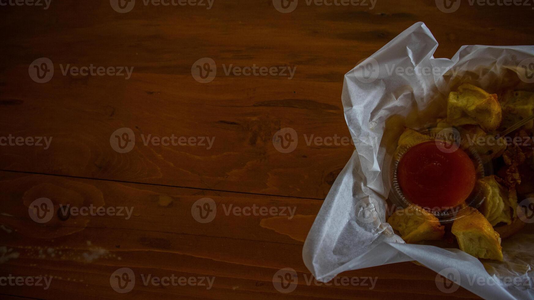 batagor o abreviado desde bakso tahu goreng con salsa en de madera antecedentes foto