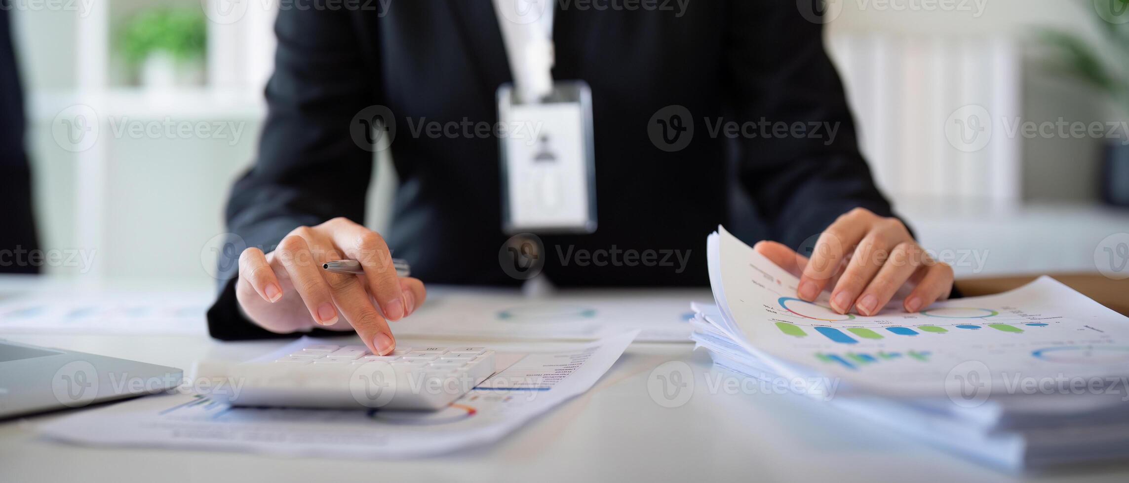 Businesswoman accountant using calculator and laptop for financial data saving in office room, Business financial, tax, accounting concept photo