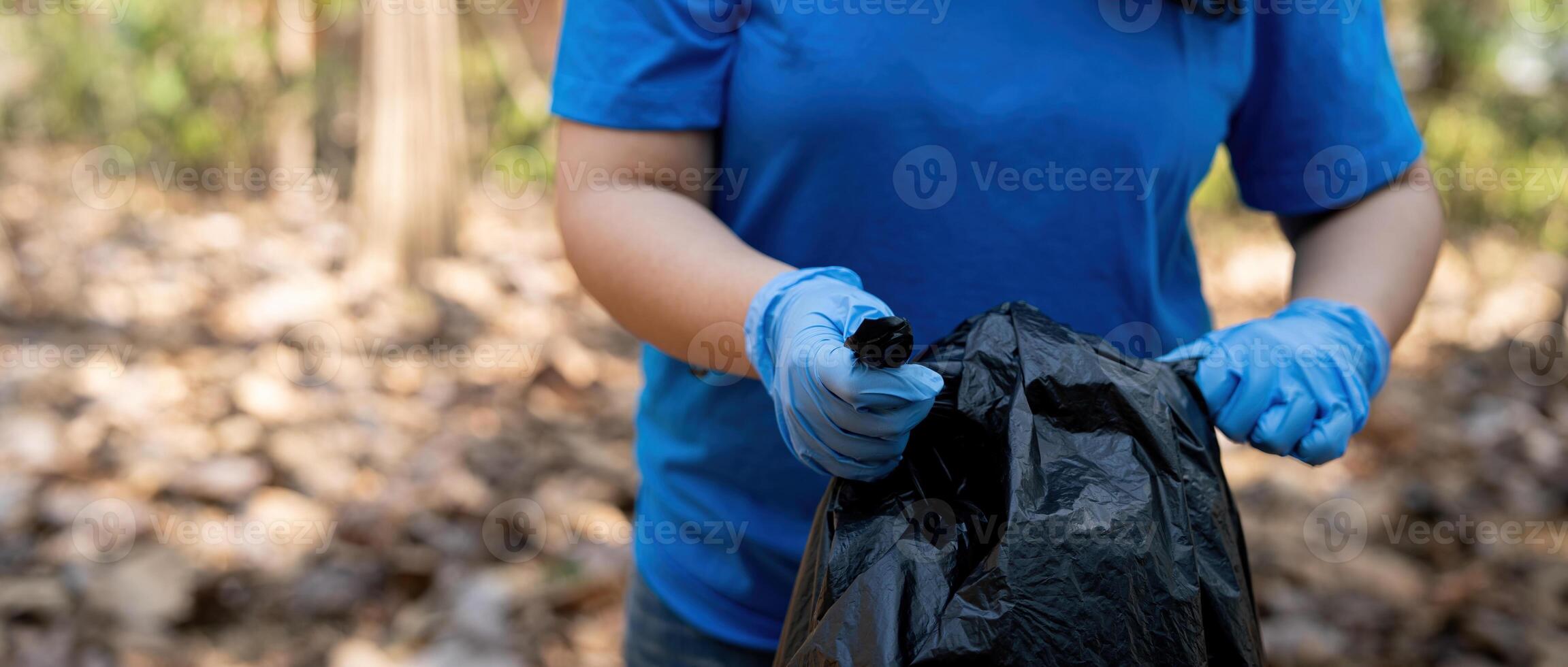 Separating waste to freshen the problem of environmental pollution and global warming, plastic waste, care for nature. Volunteer concept carrying garbage bags collecting the garbage photo