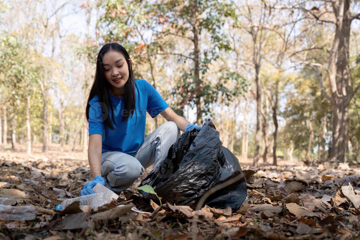 Separating waste to freshen the problem of environmental pollution and global warming, plastic waste, care for nature. Volunteer concept carrying garbage bags collecting the garbage photo
