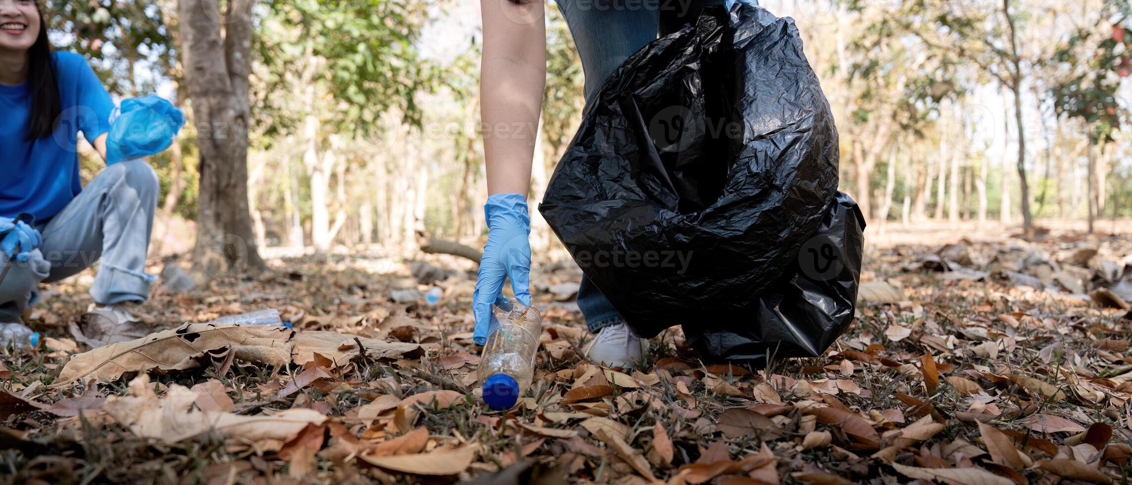 Separating waste to freshen the problem of environmental pollution and global warming, plastic waste, care for nature. Volunteer concept carrying garbage bags collecting the garbage photo