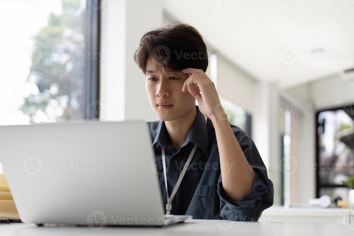 Thinking and stress Asian office employee feeling bored and tired, unhappy and burnout working in office photo