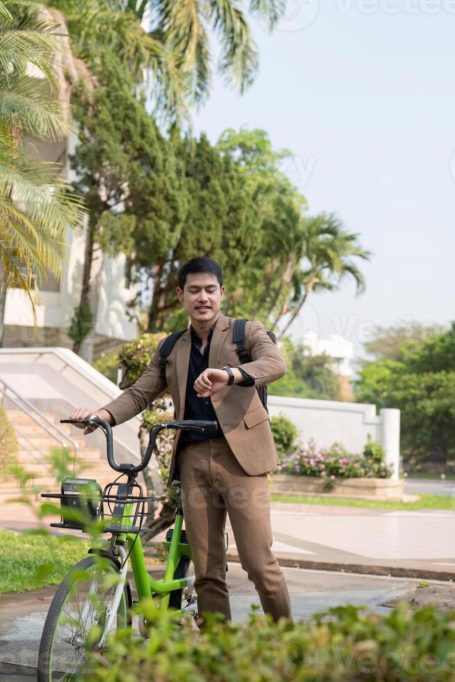 The businessman eco friendly transportation, cycling through the city avenues to go to work. sustainable lifestyle concept photo