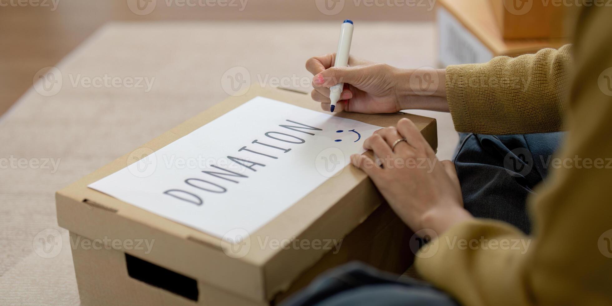Woman asian preparing a delivery box with her used clothes, Donation and recycling concept photo