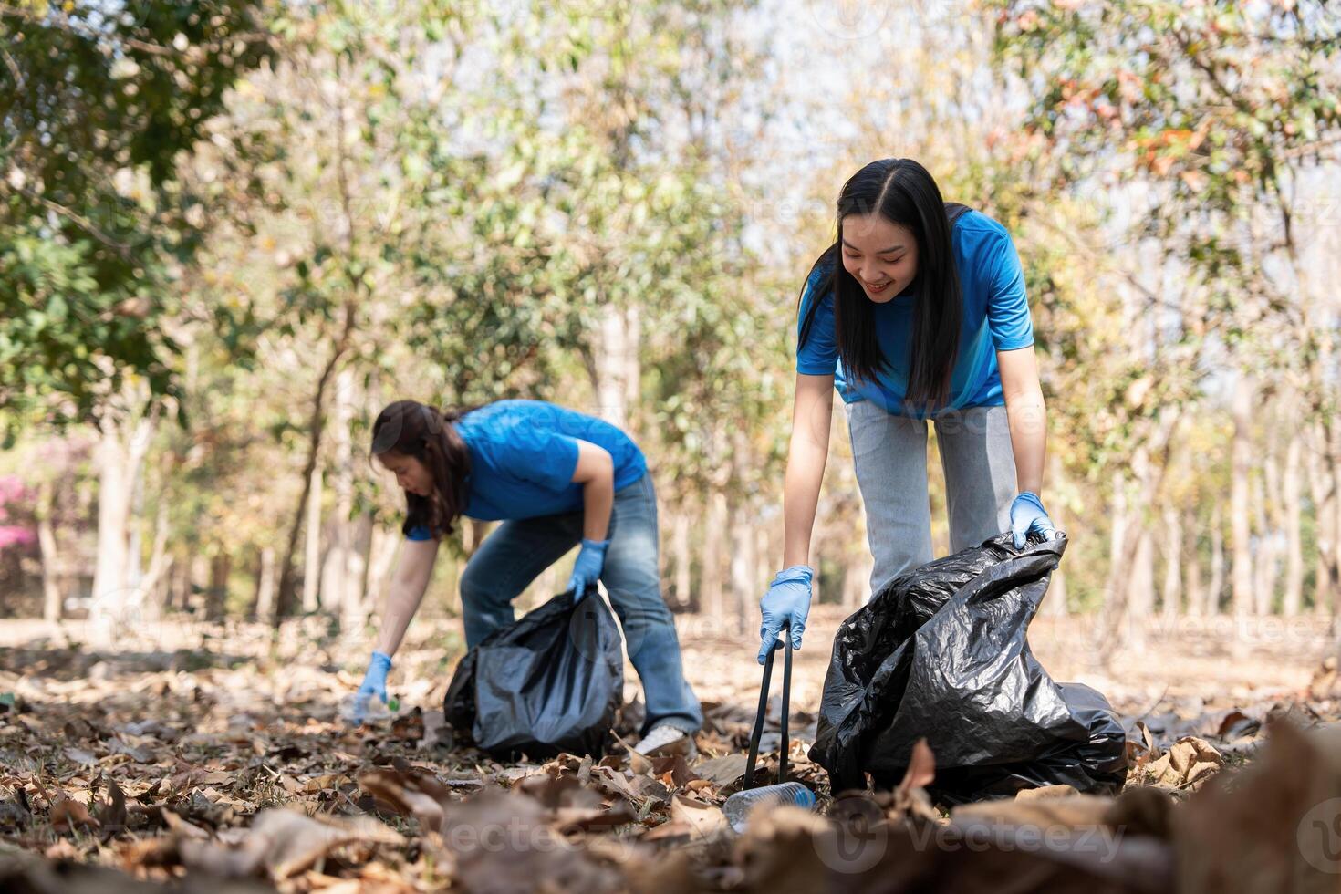 Volunteer collecting plastic trash in the forest. The concept of environmental conservation. Global environmental pollution. Cleaning the forest photo