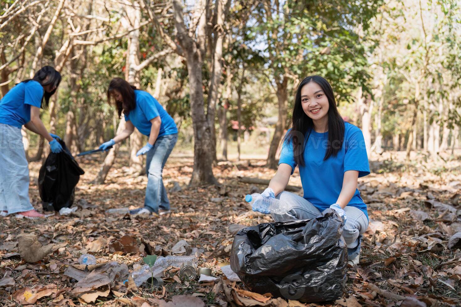 Volunteer collecting plastic trash in the forest. The concept of environmental conservation. Global environmental pollution. Cleaning the forest photo