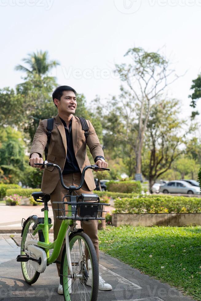 The businessman eco friendly transportation, cycling through the city avenues to go to work. sustainable lifestyle concept photo