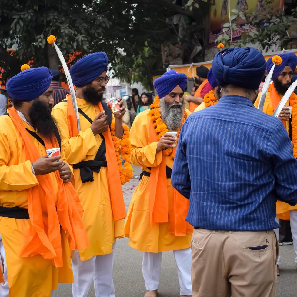 Delhi, India, October 2, 2023 - Sikhs display gatka and martial arts during annual Nagar Kirtan, Traditional, procession on account of birthday of Guru Nanak Dev ji, Nagar Kirtan in East Delhi area photo