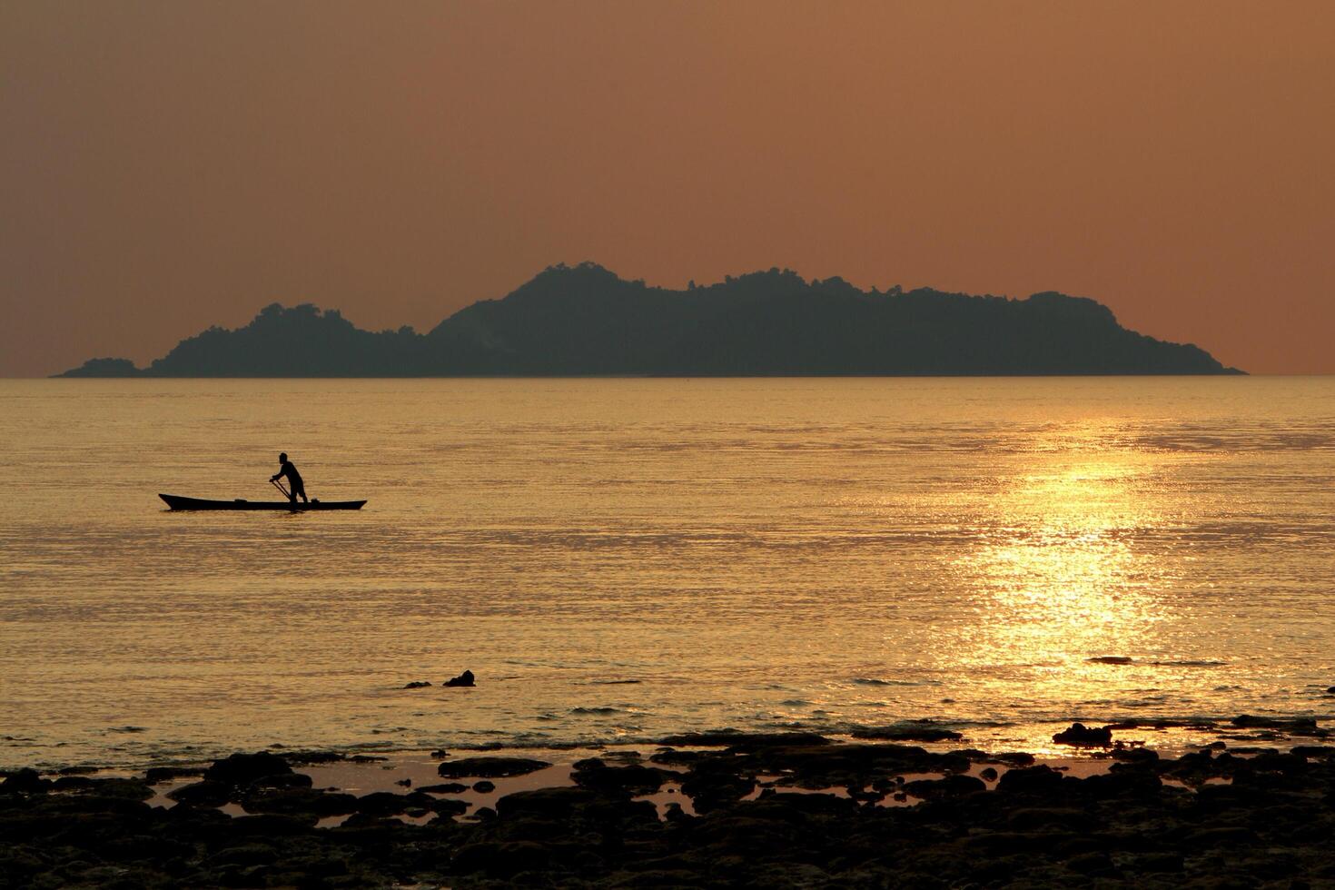 Silhouette of sea fisherman. photo