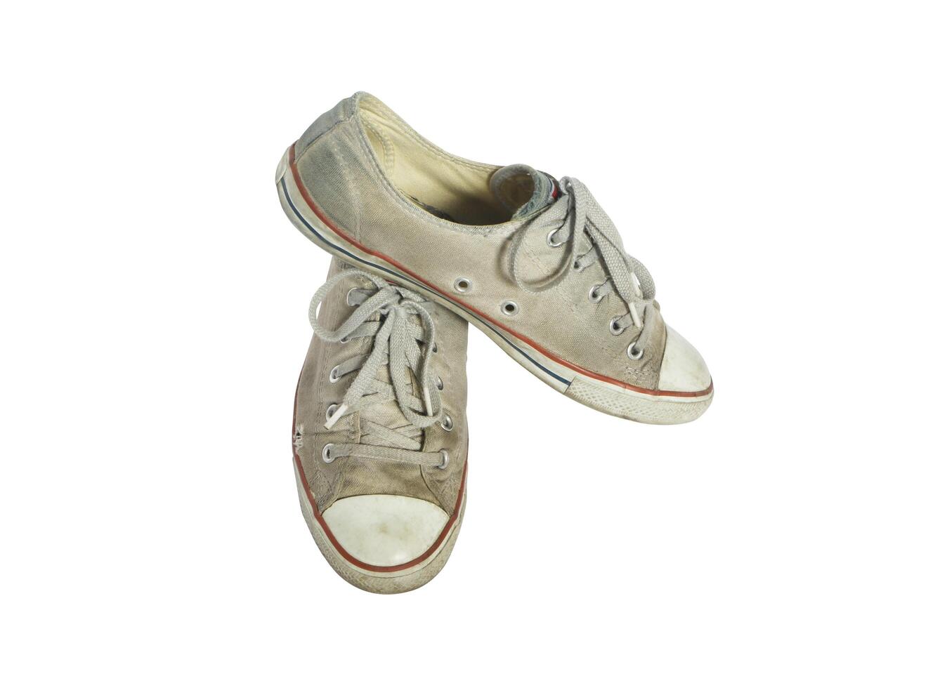 Old canvas shoes isolated on white background with clipping path. photo