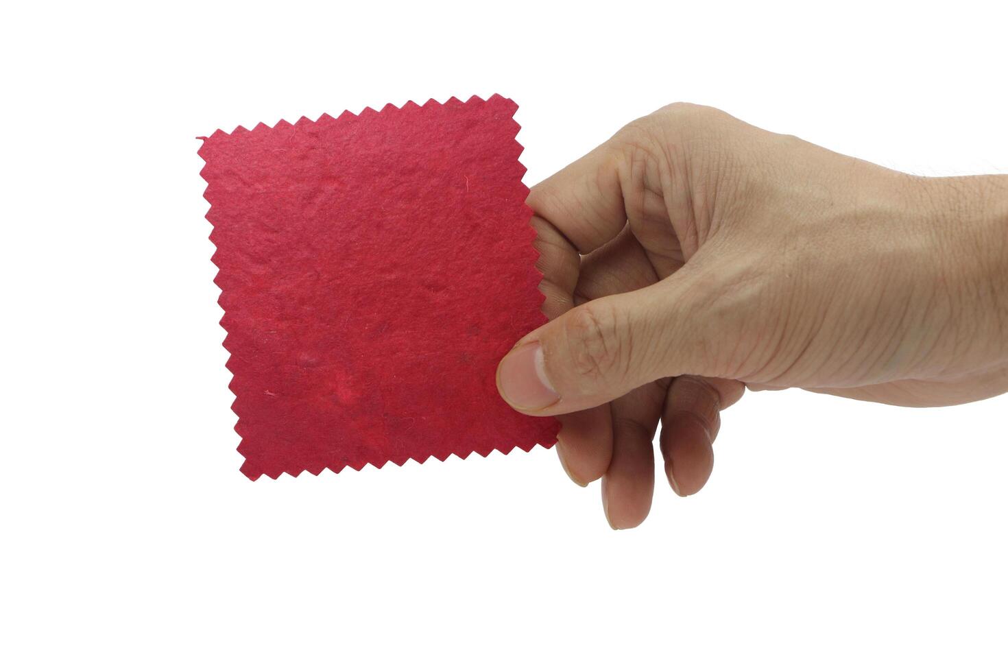 The man's hand holds a red blank paper isolated on white background. photo