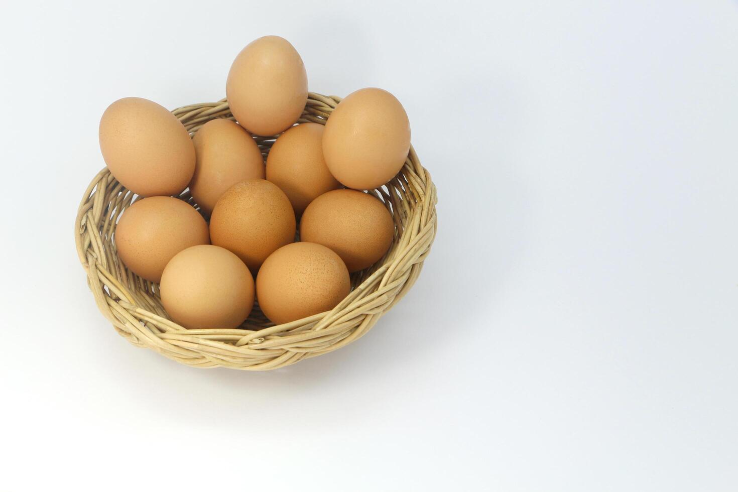 Many eggs in the basket isolated on white background. photo