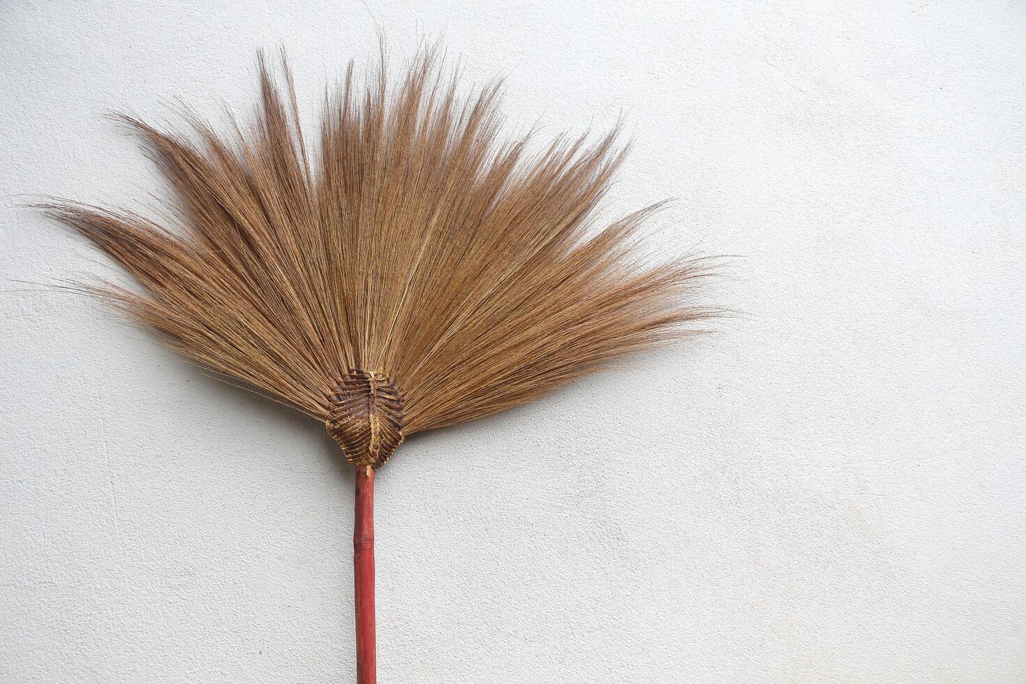 Broom on the concrete wall. photo