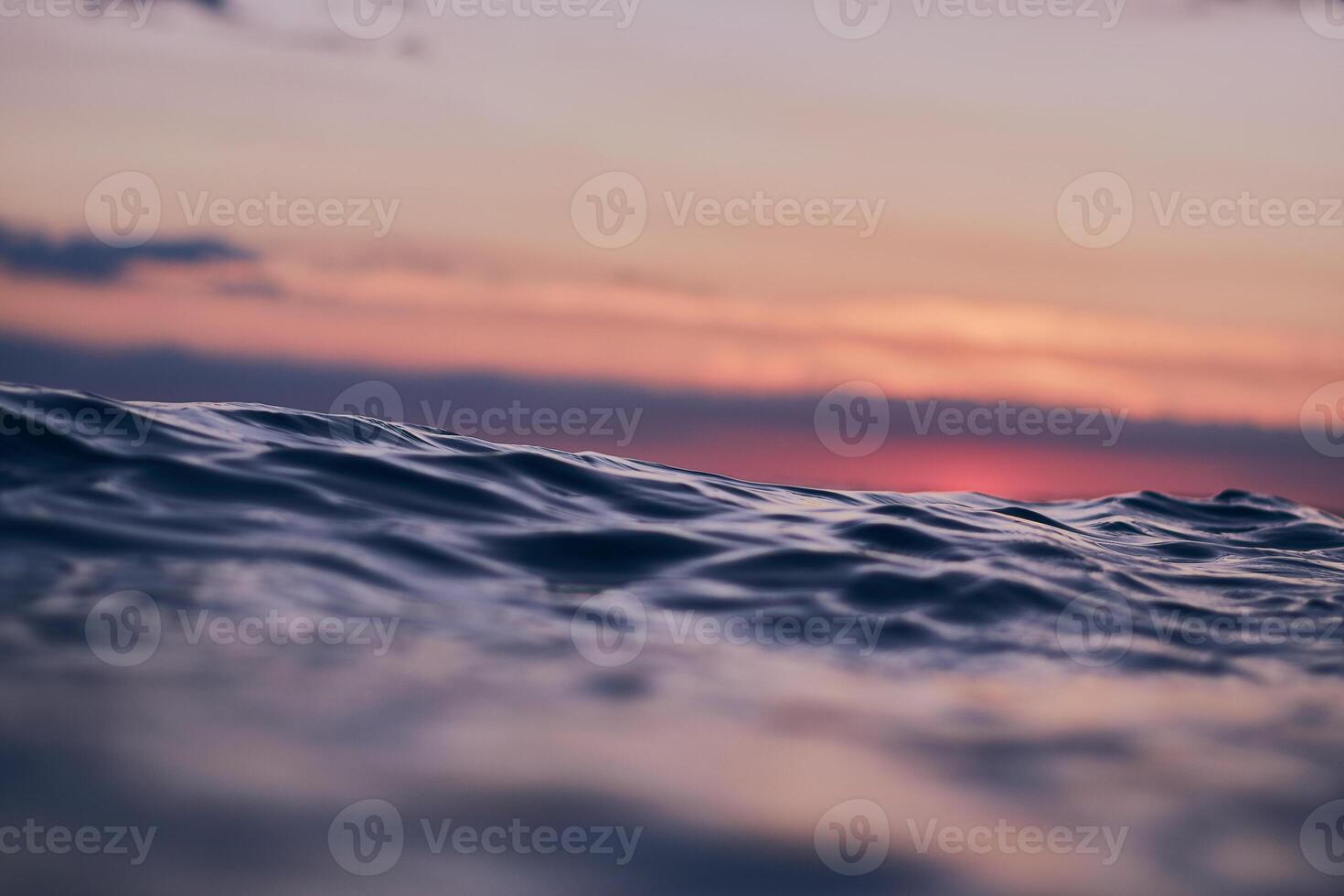 blue wave against red evening sky photo