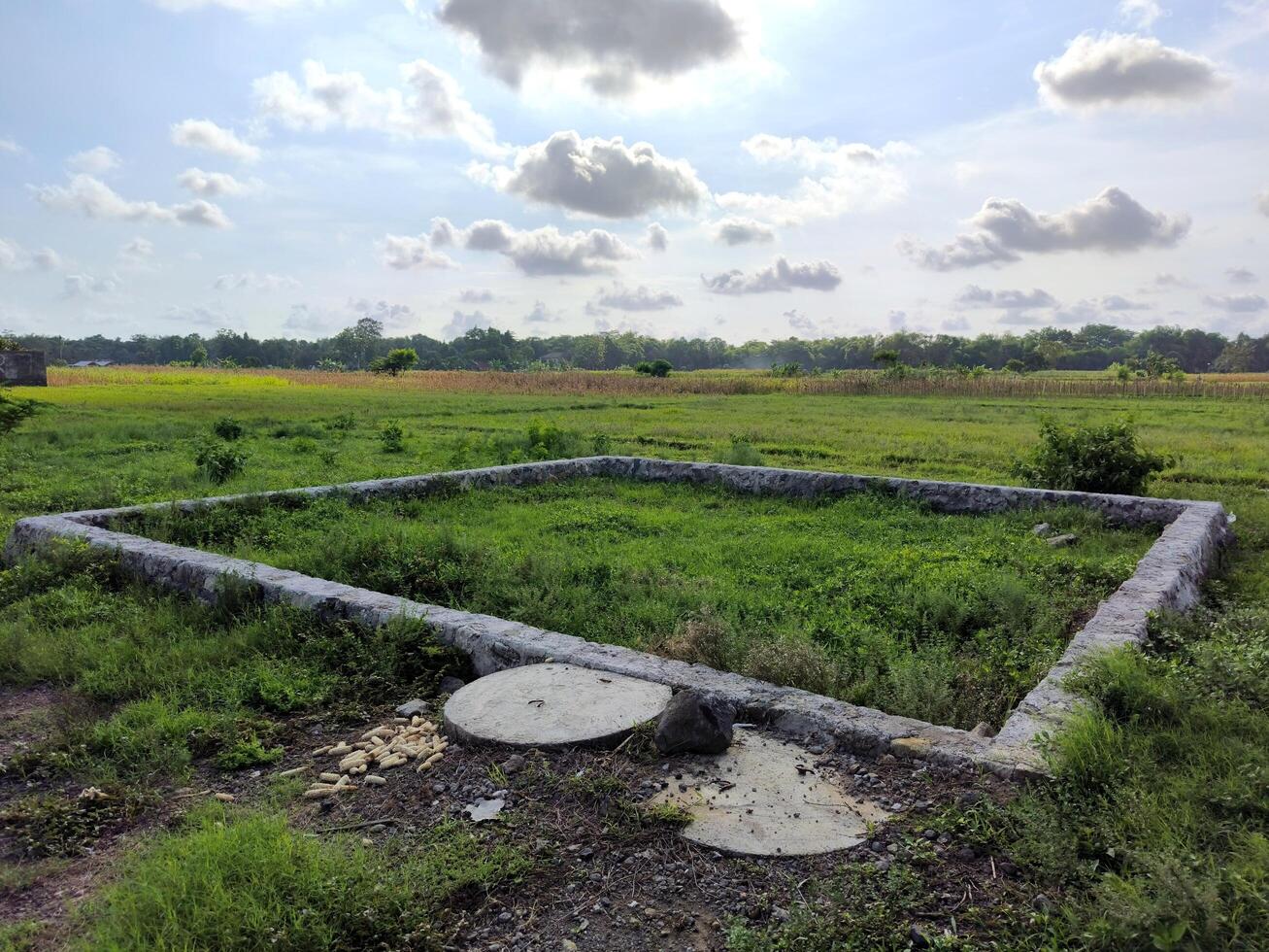 Abandoned building foundations on empty land photo