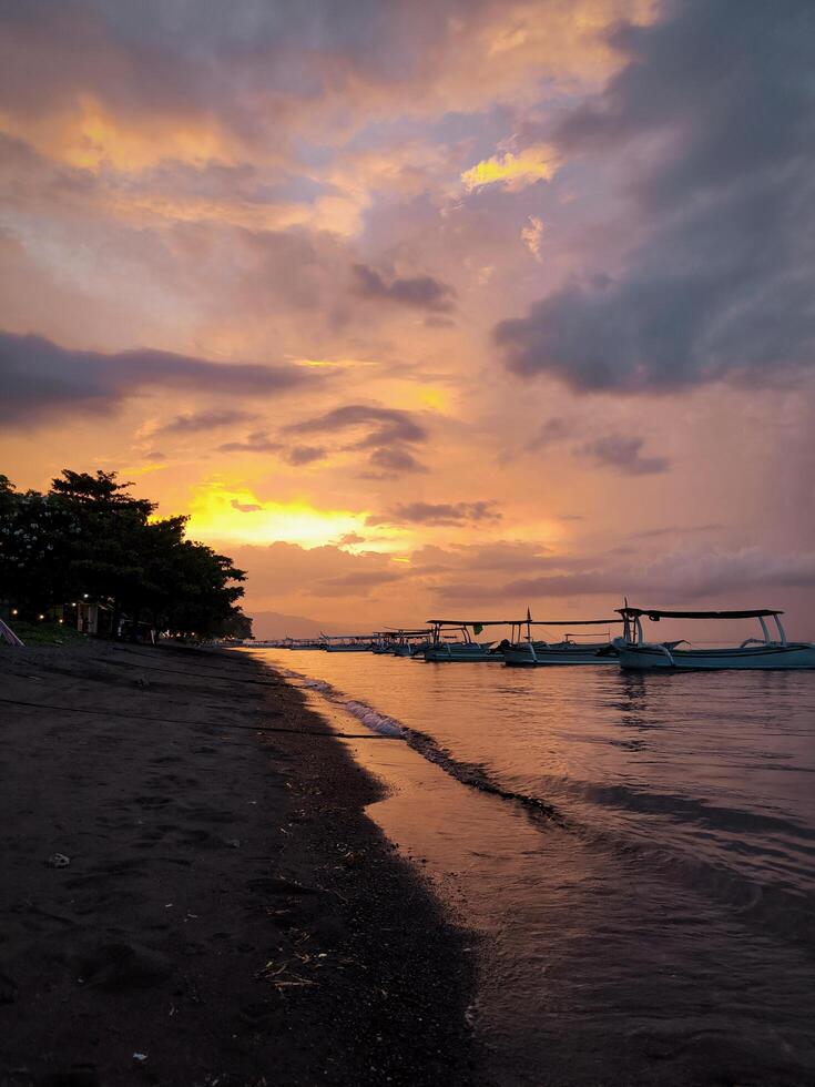 Fishing boats anchor on the beach in the afternoon, when the sunsets photo