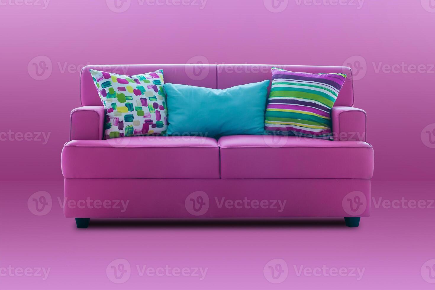 pink couch with colourful pillows photo