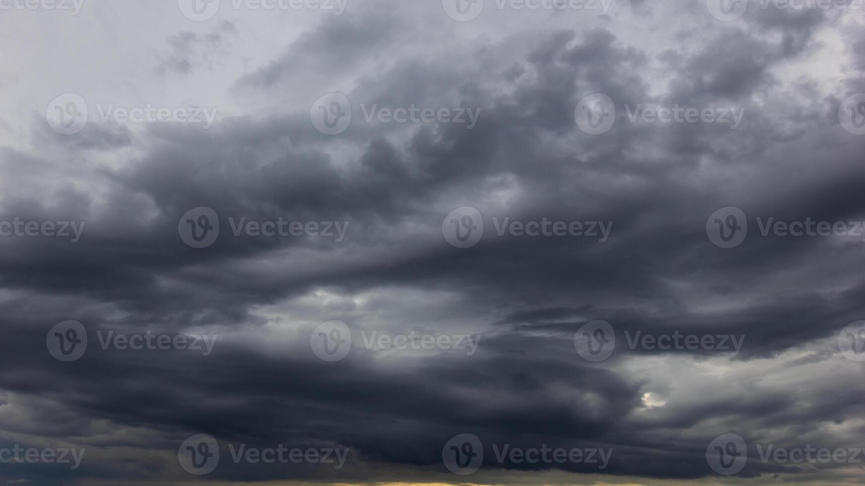 The dark sky with heavy clouds converging and a violent storm before the rain.Bad or moody weather sky and environment. carbon dioxide emissions, greenhouse effect, global warming, climate change photo