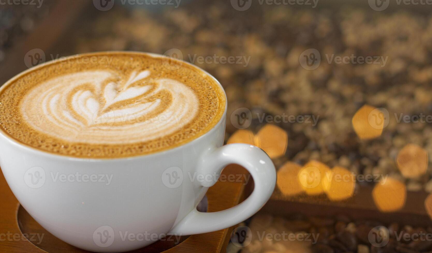 Latte art coffee with bokeh of lights on table, Dark tone. photo