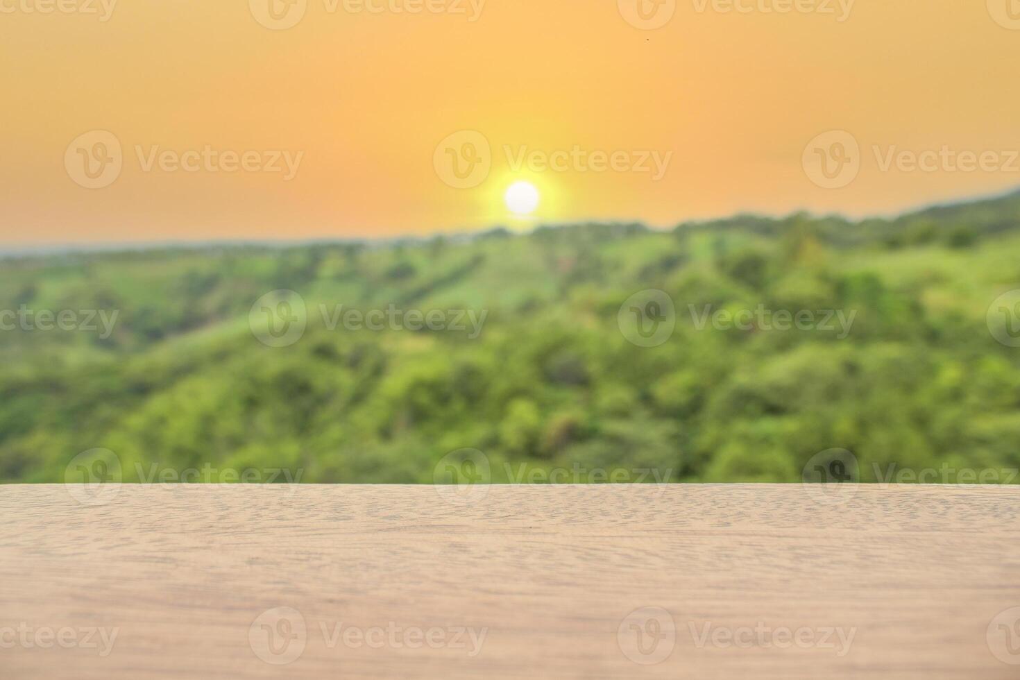 Wood table top on blurred background of sun set - can used for display or montage your products. photo