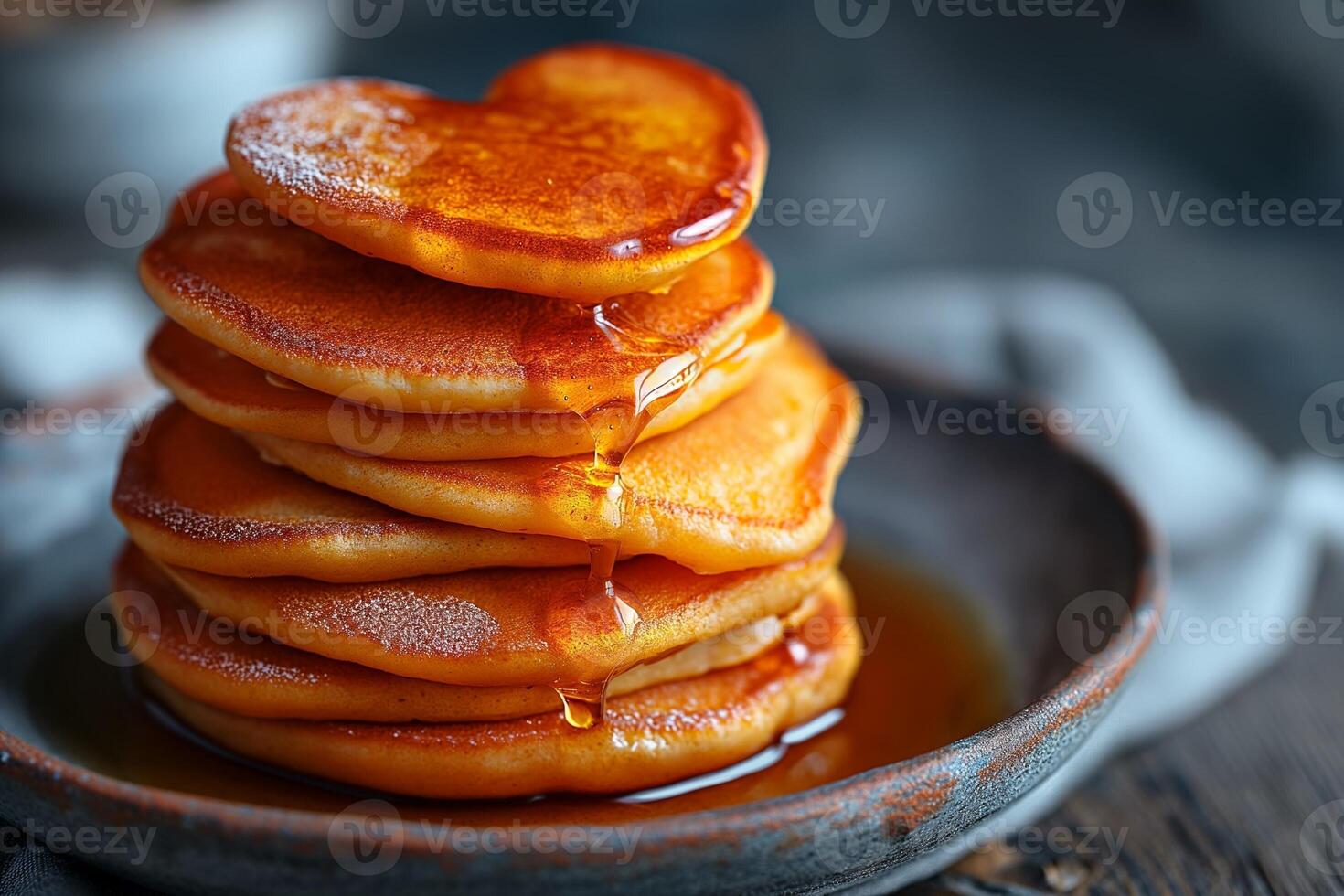 AI generated stack of heart-shaped pancakes with honey on a plate. View from above. Served on the kitchen table for breakfast photo