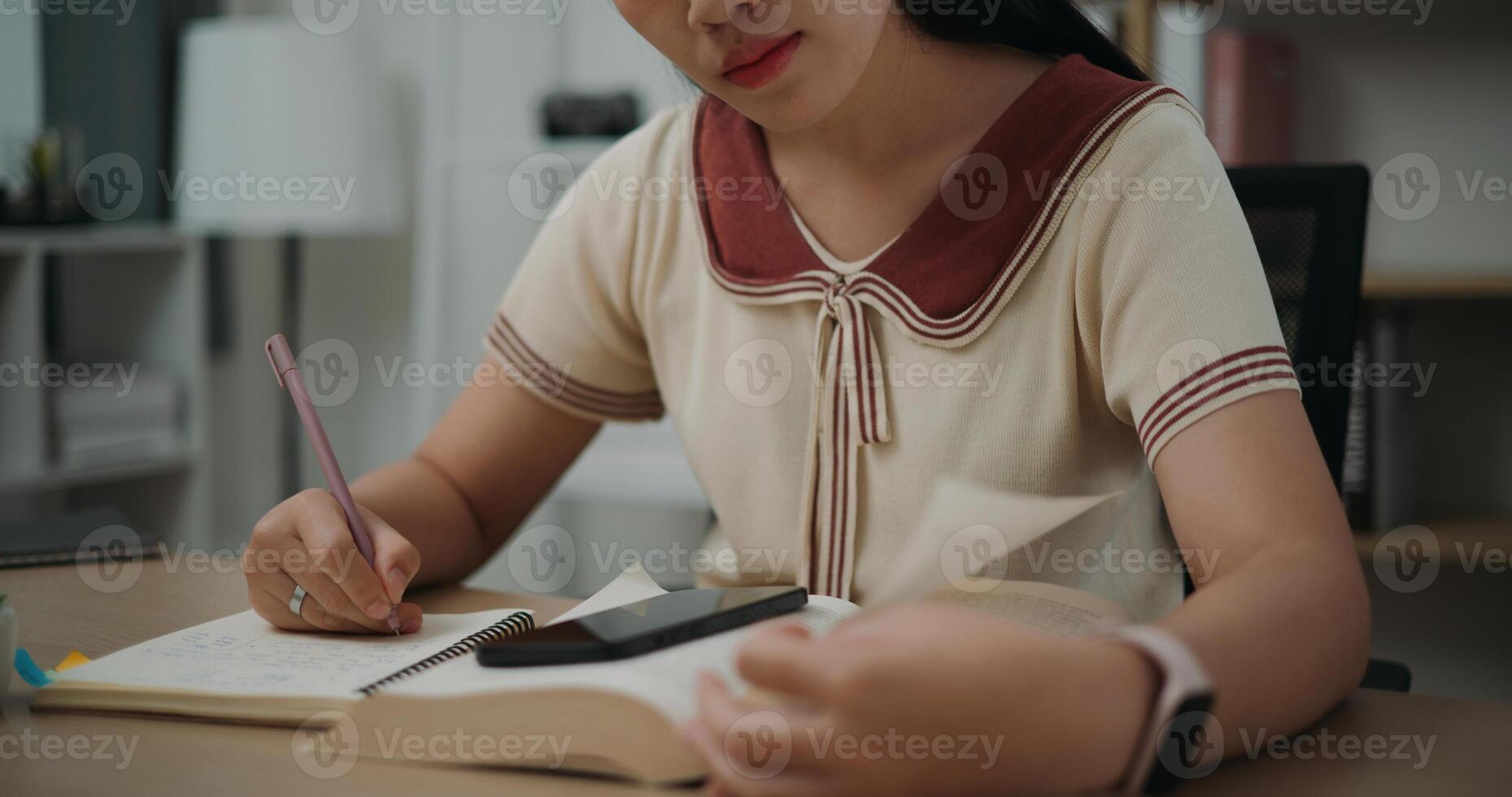 Selective focus, Hands of Female writer sitting at desk writing information on diary notebook while reading book at home, creative thoughts to journaling, idea and inspiration photo