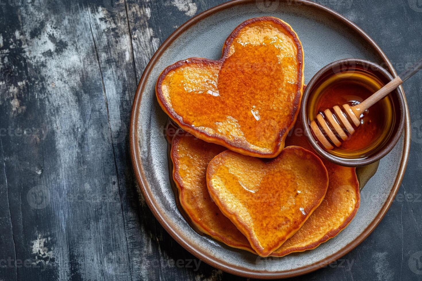 AI generated stack of heart-shaped pancakes with honey on a plate. View from above. Served on the kitchen table for breakfast photo