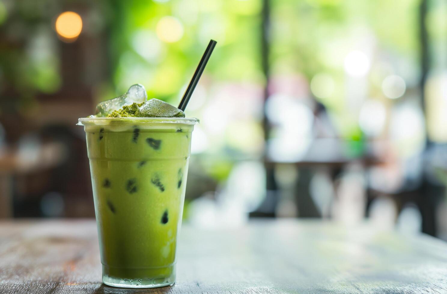 AI generated Iced matcha latte on cafe table photo